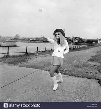 young-woman-wearing-a-hat-mini-skirt-and-knee-high-boots-on-the-sea-B56MCJ.jpg